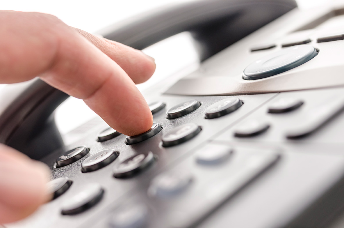 Business phone with person dialling a virtual number