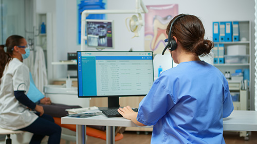 dentist-assistant-making-appointments-using-headset